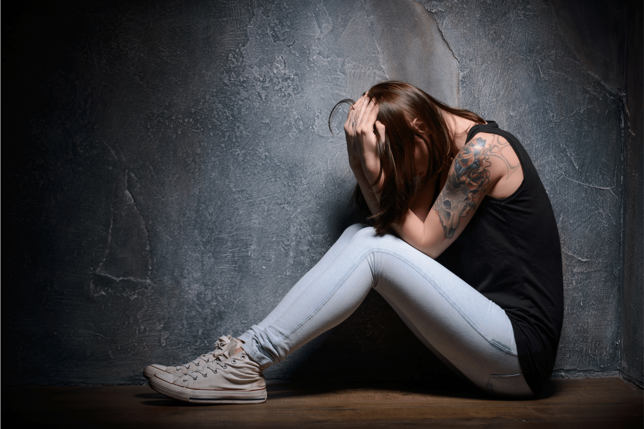 a woman with her head down after experiencing domestic violence